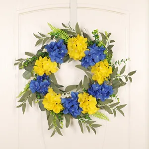 Artificial floral wreath with blue and yellow hydrangeas and green eucalyptus leaves for home decor.