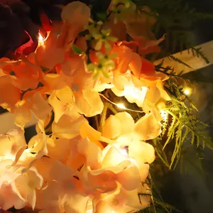 Artificial hydrangea flower wreath with warm LED lights for wall and door hanging decor.