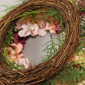 Artificial floral wreath for summer door decoration, rustic vine base with pink hydrangea flowers.
