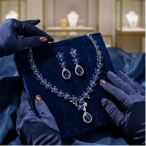 Close-up detail shot of the luxury blue sapphire zircon flower necklace and earrings jewelry.