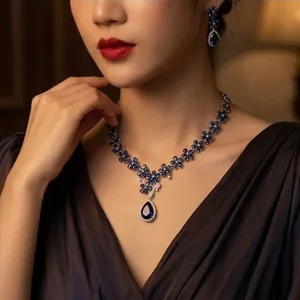 Close-up detail of the luxury sapphire colored zirconia floral necklace and earrings set.
