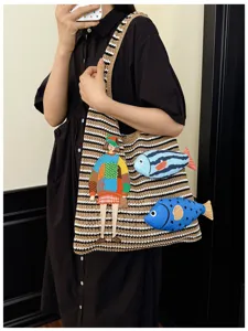 Knitted striped tote bag featuring artistic girl and fish embroidery for daily commute style.