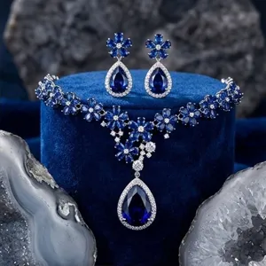 Close-up detail view of the stunning royal blue cubic zirconia floral necklace and earrings set.