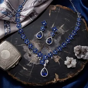 Detailed view of luxury sapphire blue zircon teardrop necklace and earrings set.