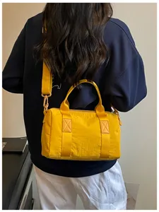 Detailed view of yellow casual crossbody shoulder bag, lightweight canvas daily commute travel handbag.