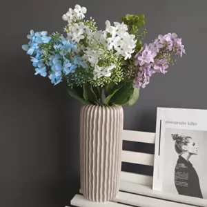 Arreglo floral de hortensias artificiales en jarrón de cerámica para detalles del hogar.