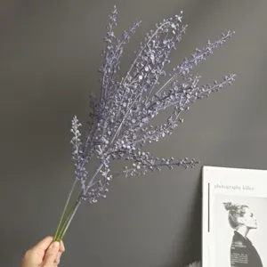 Close-up detail of artificial purple berry fruit branch floral accessory for home decor.