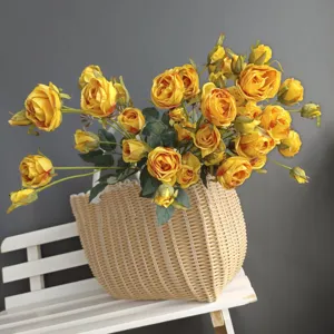 Close-up detail of beautiful artificial yellow roses bouquet arranged in a woven basket.