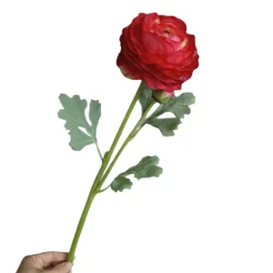 Artificial ranunculus flower with two heads and green leaves for home and wedding decoration.