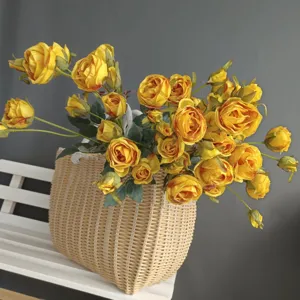 Artificial yellow rose bouquet in woven basket for Nordic home decor and wedding interior design.