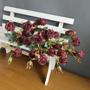 Closeup detail view of artificial dark red rose bouquet, ideal for home decor and staging.