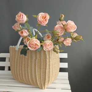 Artificial pink rose flower bouquet arrangement in woven basket for home interior decor detail