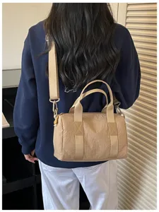 Khaki barrel shoulder bag detail, stylish women's crossbody bag for daily commute and travel