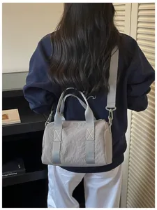 Casual crossbody shoulder bag for women, lightweight commuter travel handbag with top handles and strap.