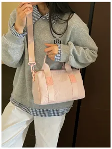 Casual pink cylindrical crossbody handbag, lightweight daily commuting travel shoulder bag.