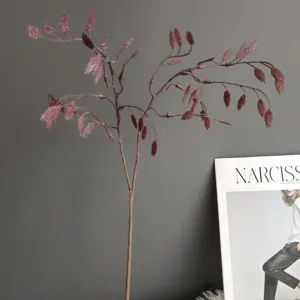 Artificial plant detail showing delicate red oat grass branch for home decor and floral design.