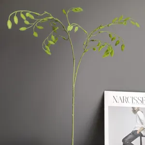 Detailed close-up of artificial green oat grass branch, perfect for modern home decor styling.