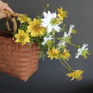 Close-up detail of artificial wild flowers in a woven basket, perfect for home decor display.