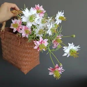 Artificial wildflower daisy nigella bouquet paired with woven basket for home decor.