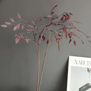 Artificial oat grass stems detail shot, red-brown decorative foliage for home decor and floral design.