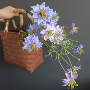 Artificial flower bouquet with woven basket and bamboo handle for home decor photography prop