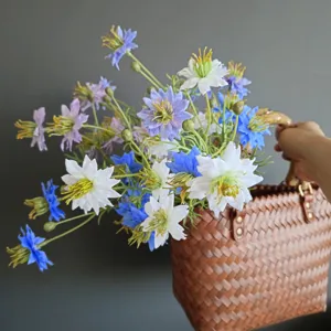 Detailed view of artificial wildflower bouquet in woven basket for home decor photography props.