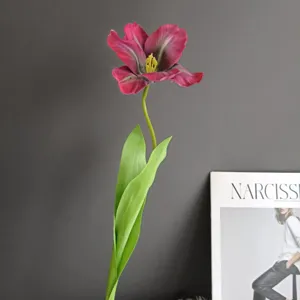Detalle de flor de tulipán artificial, tallo único rosa oscuro con hojas verdes para el hogar.