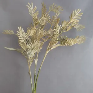 Gold artificial fern leaf branch for home decor, floral arrangement, wedding and interior design.