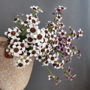 Artificial daisy flower detail shot with flocked core for Nordic home decor and photo props.