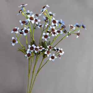 Detailed view of artificial blue daisy wildflowers with fuzzy brown centers for home decor.