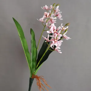 Artificial orchid flower stem detail, realistic pink spotted petals and green leaves