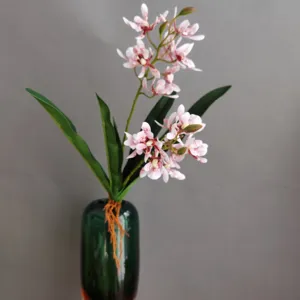 Detailed view of artificial orchid flower in glass vase for modern home hotel decor