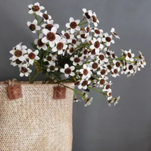 Artificial daisy wildflower bouquet in woven basket for home decor photography props