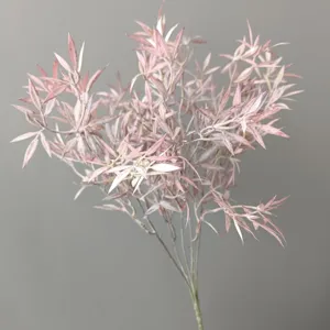 Close-up detail of artificial pink flocked foliage branch, five forks floral decor piece.