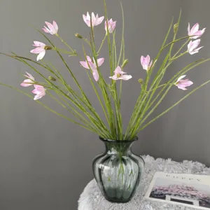 Artificial pink flower bouquet in glass vase for home decor, elegant floral arrangement prop.