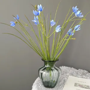 Artificial blue flower bouquet in dark green glass vase, elegant desktop home decor prop detail