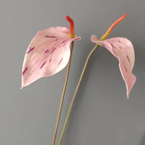 Detailed close-up of artificial pink anthurium, realistic decor for home and wedding.