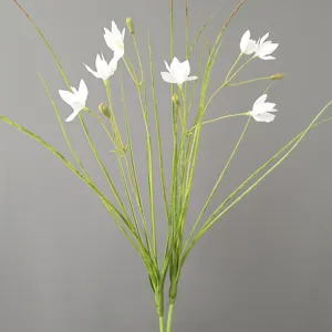 Artificial white flower detail shot, faux rain lily and green grass stems for home decor.
