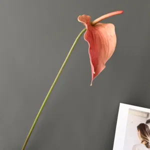 Artificial anthurium flower detail shot, single pink flamingo flower stem for home decor.