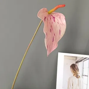 Detailed close-up of artificial anthurium flower with pink splash pattern and long stem for home.