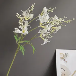 Detailed view of artificial white flower branch, ideal for interior home decor and events.