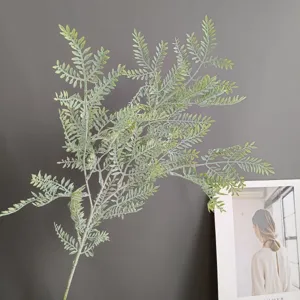 Detailed close-up of artificial fern leaf branch, realistic green foliage for home decor.