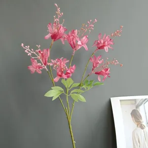 Artificial pink bamboo flower branch for home decor, wedding, and indoor decoration use.