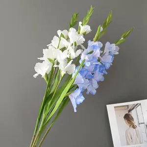 Detail shot of artificial gladiolus flower branches, realistic decor for home interior design.