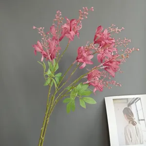 Close-up detail shot of artificial pink oleander flower branch with green leaves for home decor.