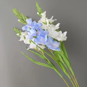 Close-up view of artificial blue and white gladiolus flowers with long stems for decor.