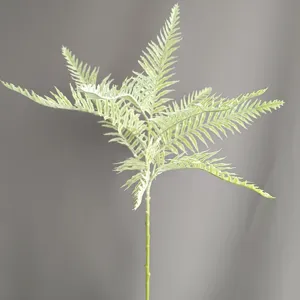 Detailed close-up shot of artificial fern leaf branch, soft rubber plant for home decor.
