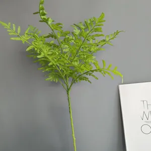Primo piano dettagliato di ramo di felce artificiale, fogliame verde per decorazione.
