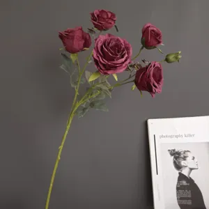 Artificial burgundy rose flower branch for home decor, wedding arrangement, and interior styling.
