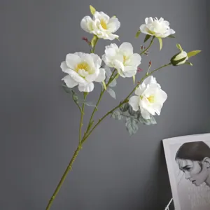 Artificial white wild rose flower branch detail, realistic fabric floral decor for home interior.